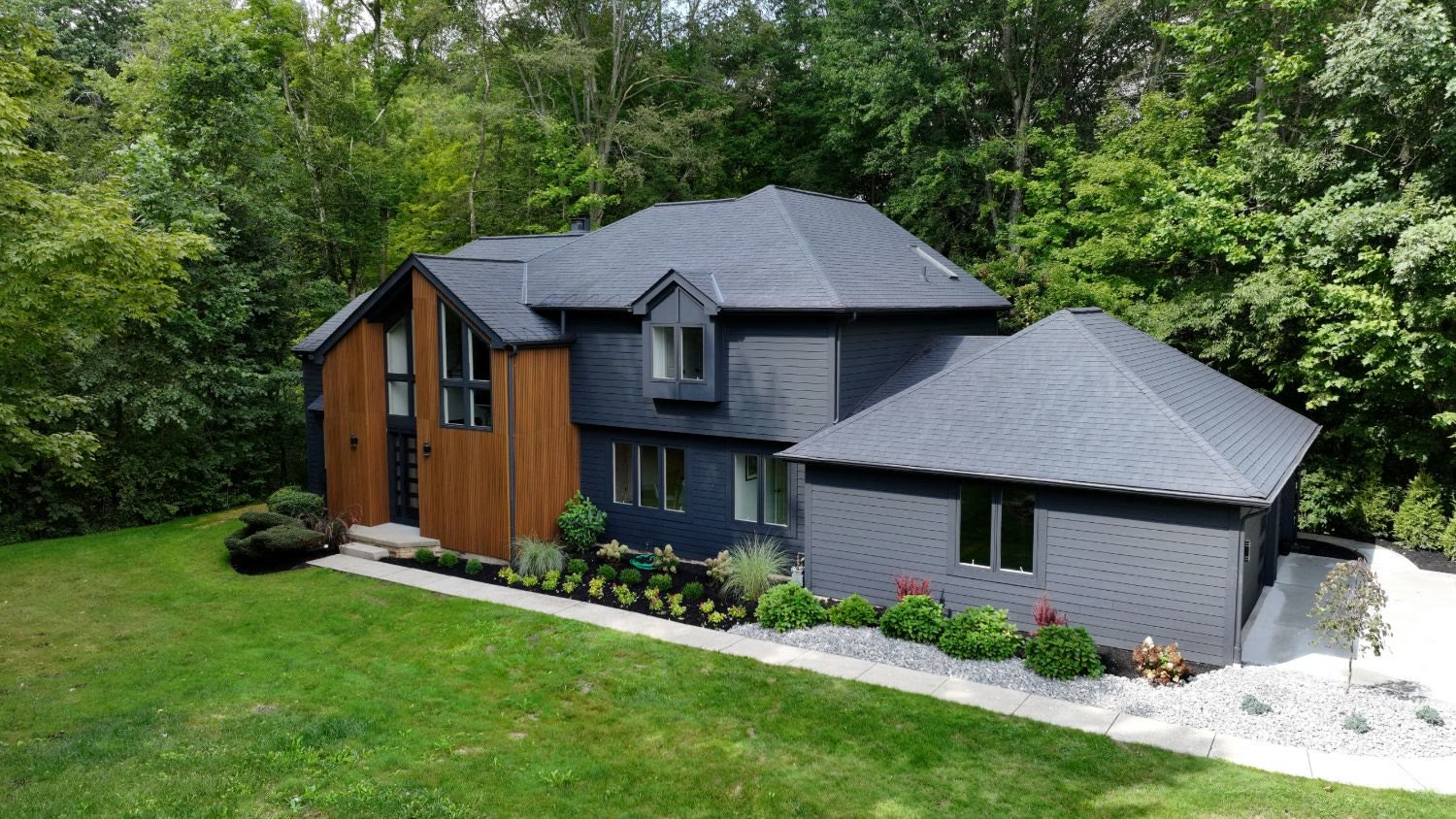 Aerial view of a modern home with wood and charcoal siding